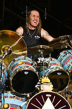 Nicko McBrain  Drummer from Legendary Rock Group Iron Maiden One free autographed photo provided at stage. Additional or other items require a fee.